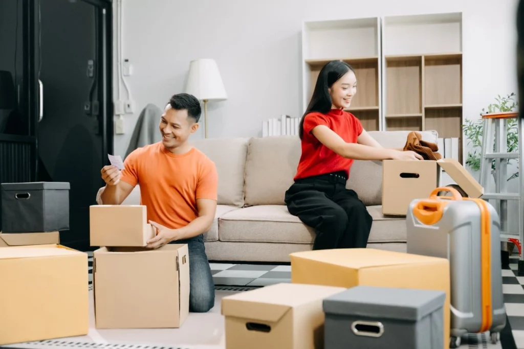 compressed adults packing cardboard boxes on the floor 2026 01 05 23 24 47 utc