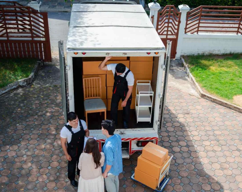 compressed movers unloading boxes and furniture from truck 2026 01 07 23 18 56 utc e1789376360575